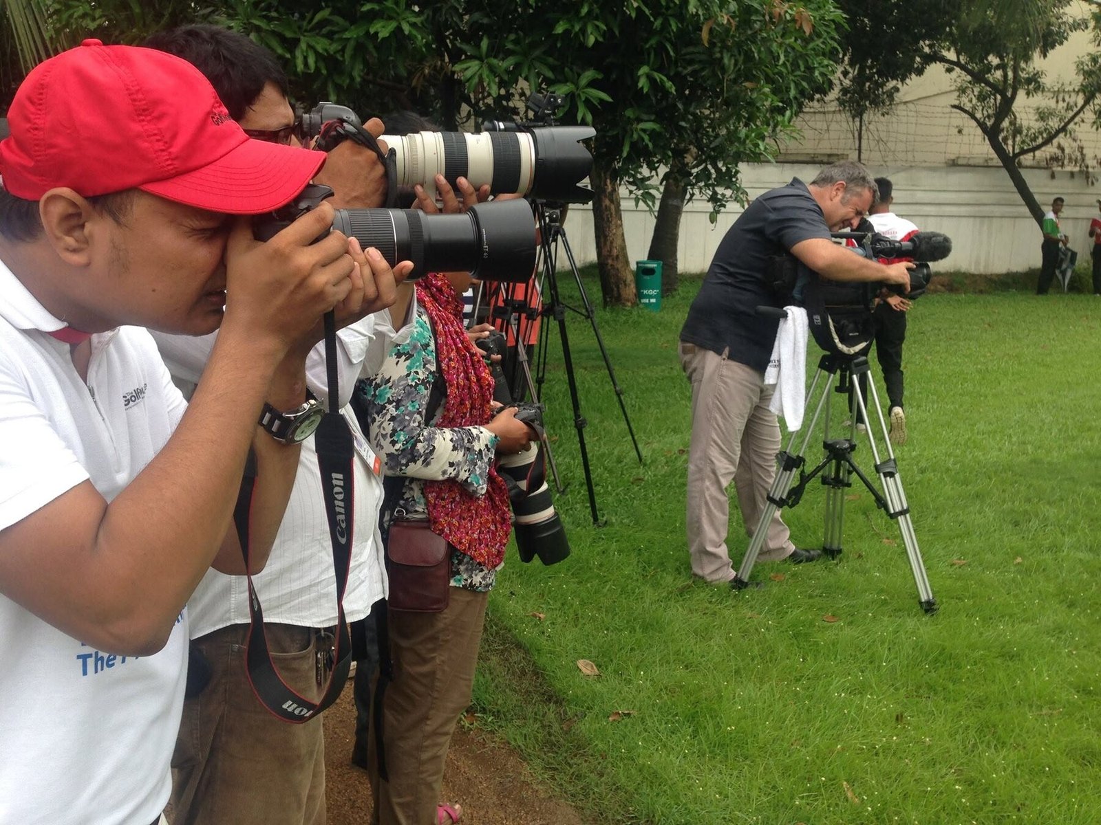Nazrul Hosen photographing golf coverage with a media team