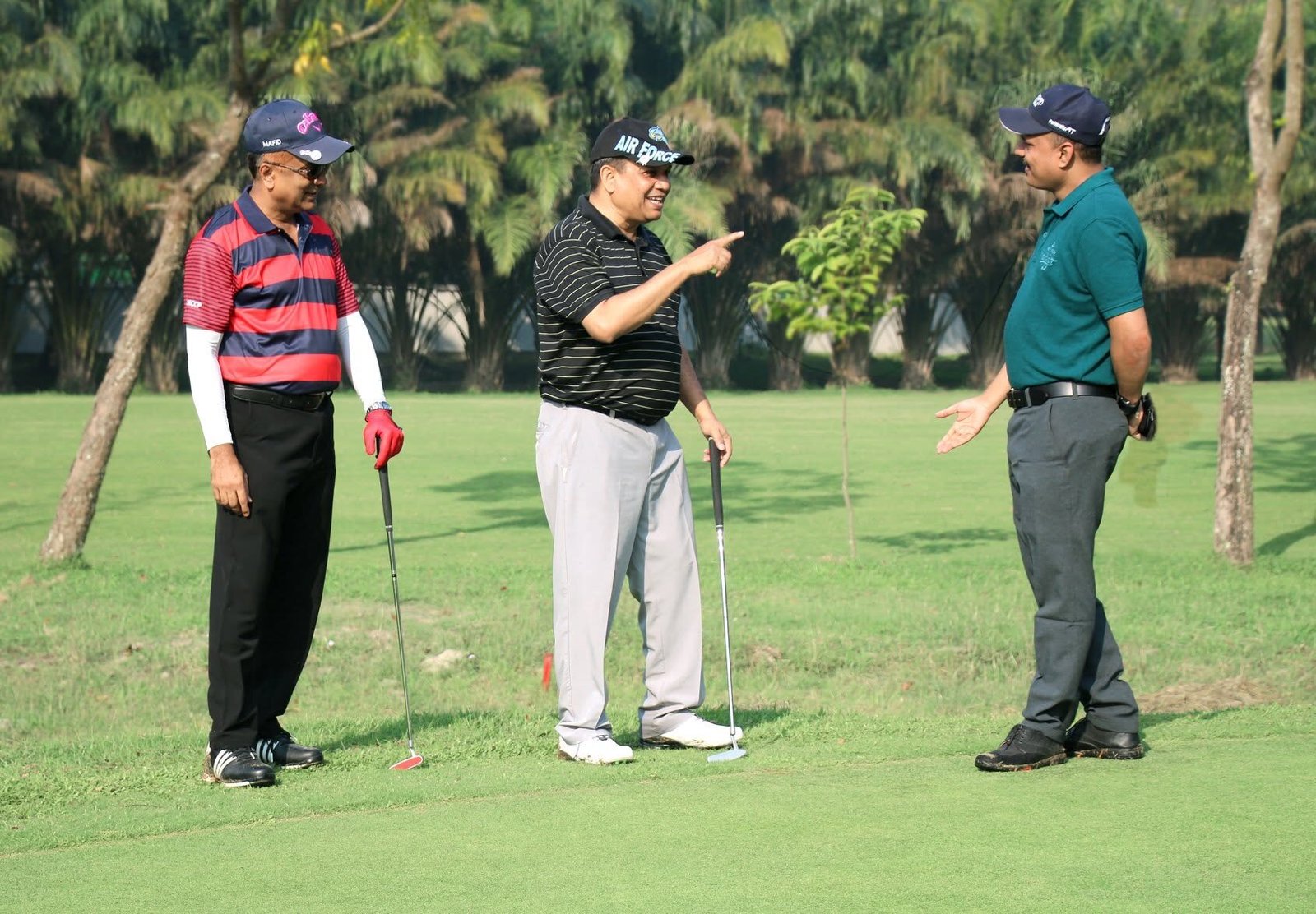 Nazrul Hosen in conversation with golfers on a course