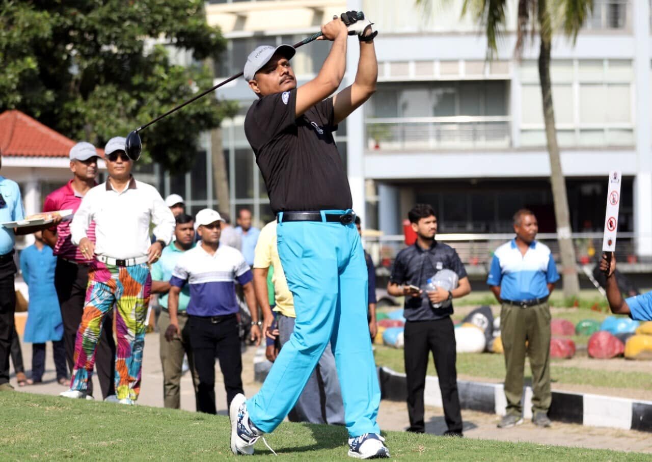 A golfer taking a tee shot during a tournament